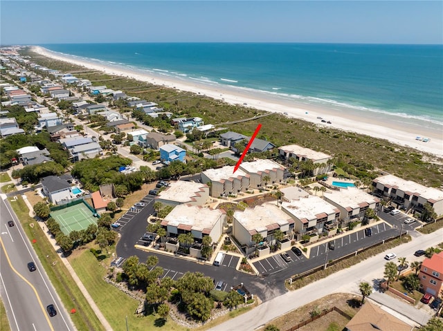 birds eye view of property with a water view and a beach view