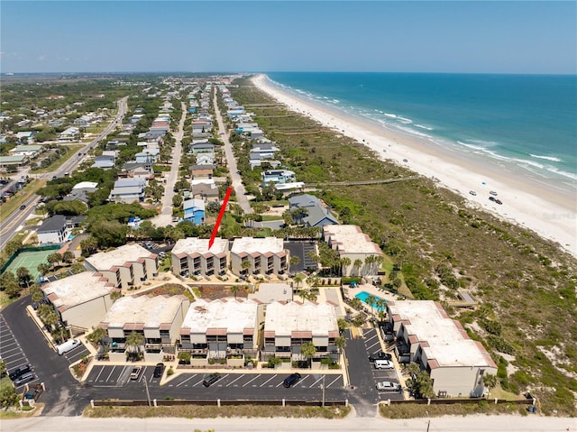 bird's eye view with a water view and a beach view