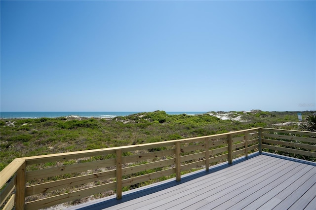 wooden terrace featuring a water view