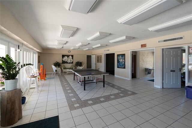 game room with light tile patterned floors