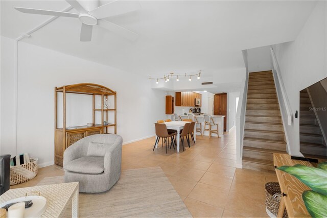 living room featuring ceiling fan and light tile patterned floors