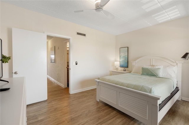 bedroom with wood-type flooring and ceiling fan