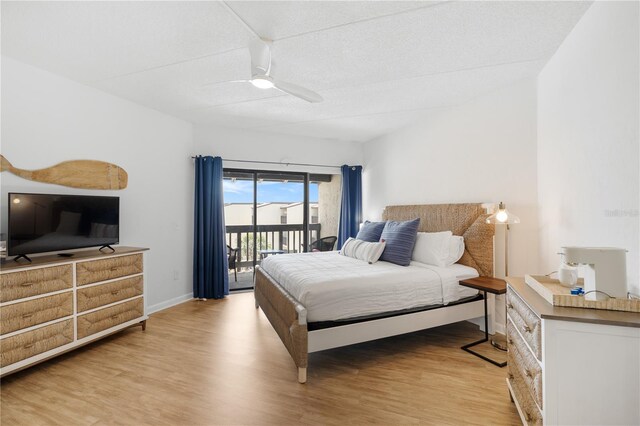 bedroom with ceiling fan, light hardwood / wood-style floors, access to exterior, and a textured ceiling