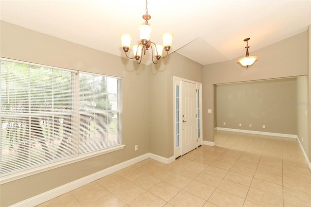 tiled empty room with a chandelier and vaulted ceiling