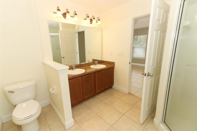 bathroom featuring walk in shower, toilet, double vanity, and tile flooring