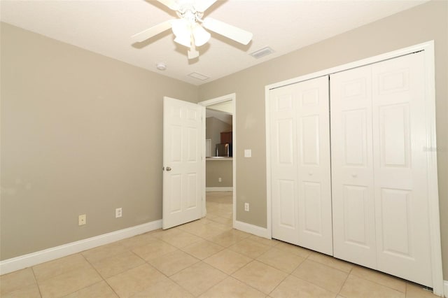 unfurnished bedroom featuring a closet, ceiling fan, and light tile floors