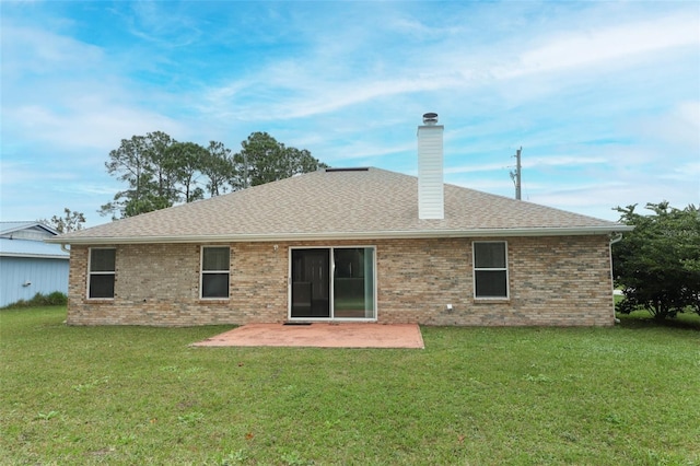 rear view of house featuring a lawn and a patio area