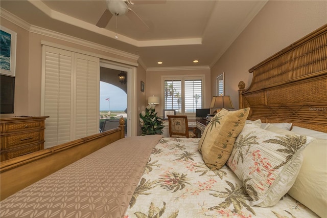 bedroom featuring a raised ceiling, ceiling fan, and crown molding