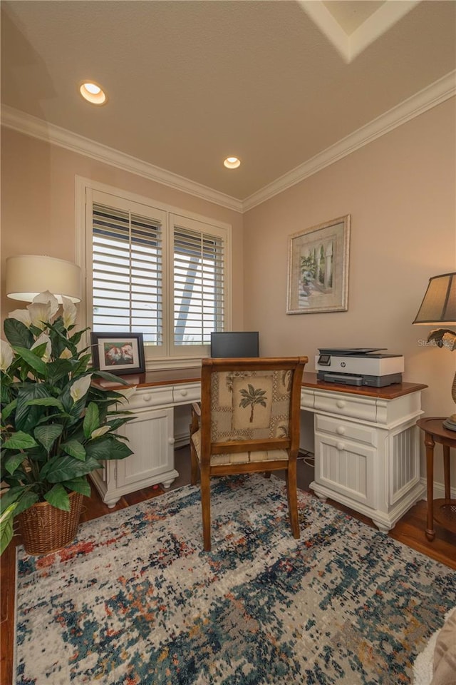 office space featuring crown molding, built in desk, and wood-type flooring