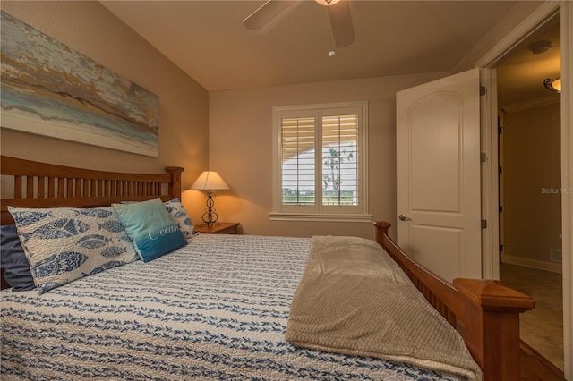 tiled bedroom featuring ceiling fan