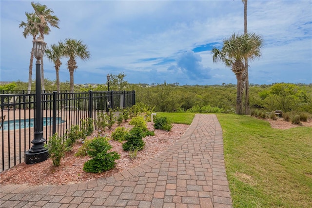 view of property's community featuring a pool and a lawn