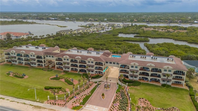 birds eye view of property with a water view