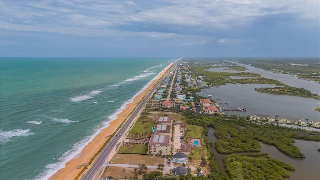 birds eye view of property featuring a water view and a view of the beach