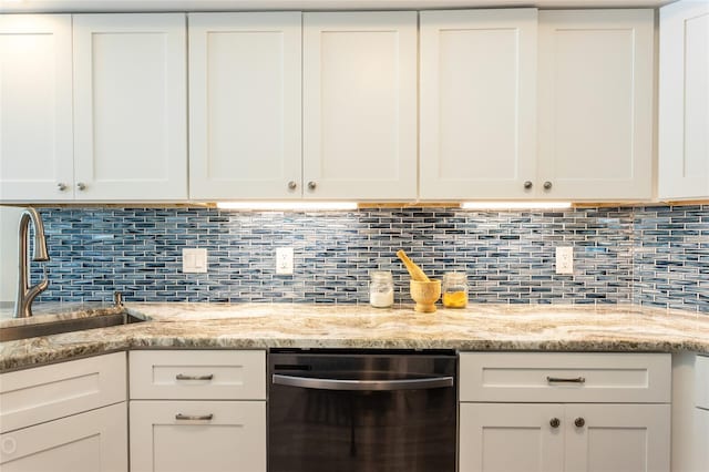 kitchen featuring white cabinetry, light stone countertops, and tasteful backsplash