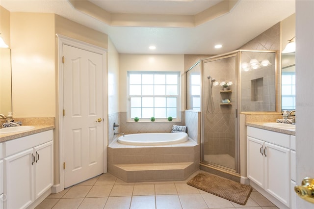 bathroom featuring tile patterned flooring, independent shower and bath, and vanity