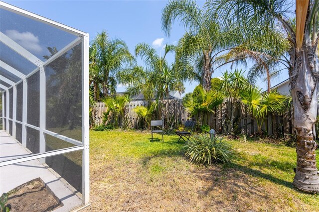 view of yard featuring a lanai