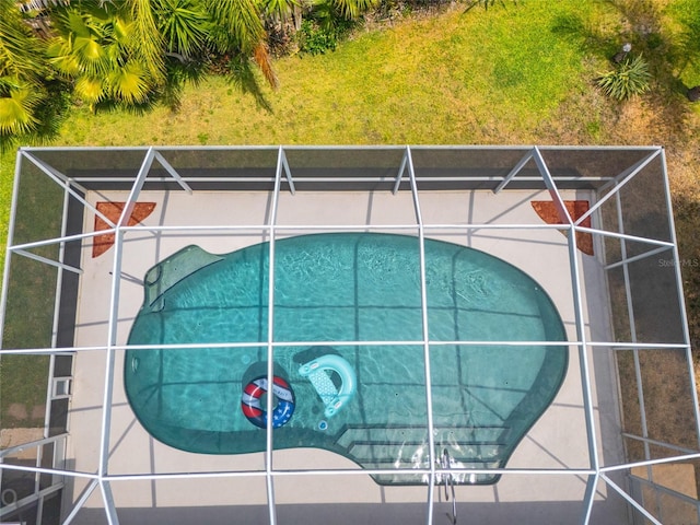 view of swimming pool with a lanai