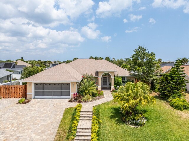 view of front of house featuring a garage and a front lawn