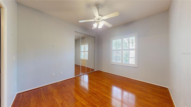 empty room with hardwood / wood-style flooring and ceiling fan