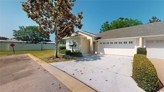 ranch-style house with a front yard and a garage