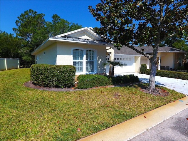 view of front of home with a front yard and a garage