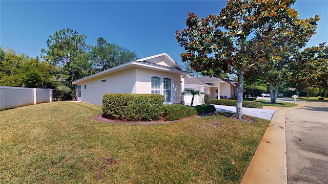 view of side of property with a lawn