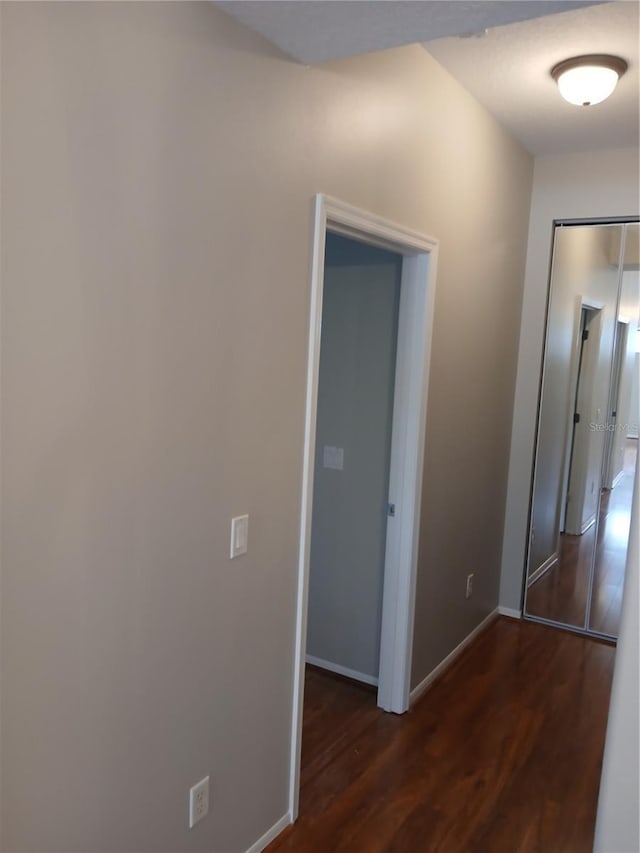 hallway with dark hardwood / wood-style floors