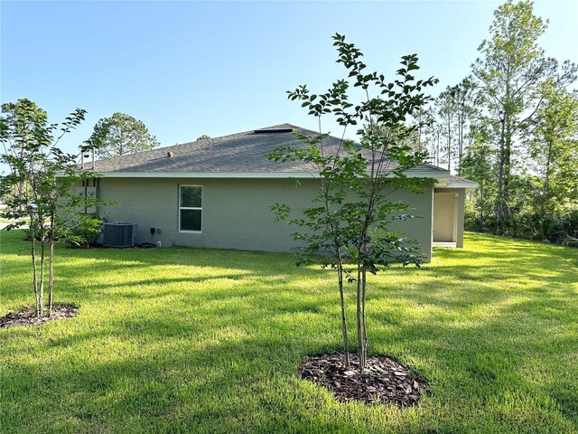 view of home's exterior with a yard and central air condition unit