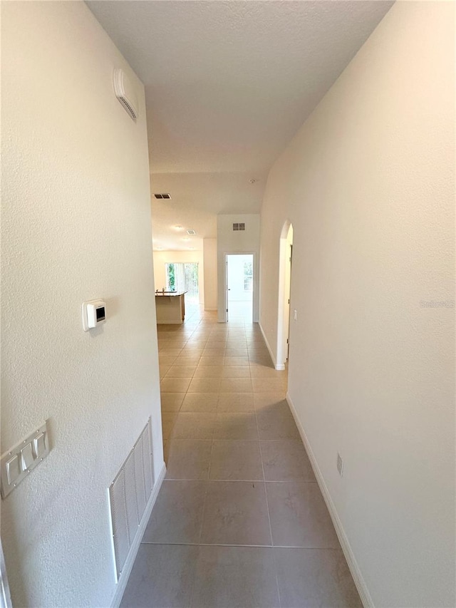 hallway with tile flooring