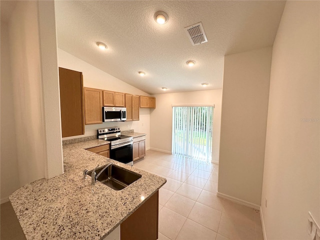 kitchen featuring light stone countertops, electric range oven, lofted ceiling, sink, and light tile floors