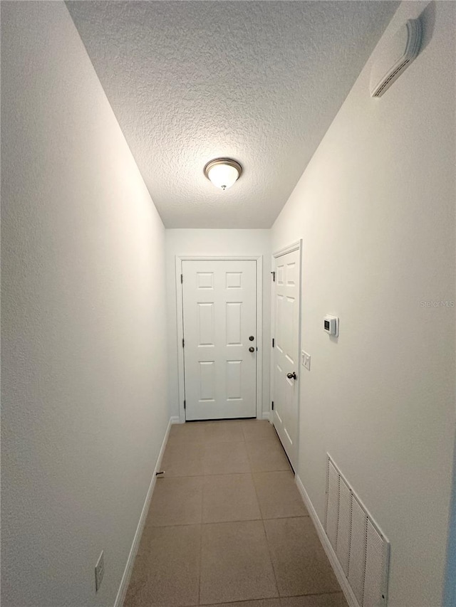 entryway featuring tile flooring and a textured ceiling