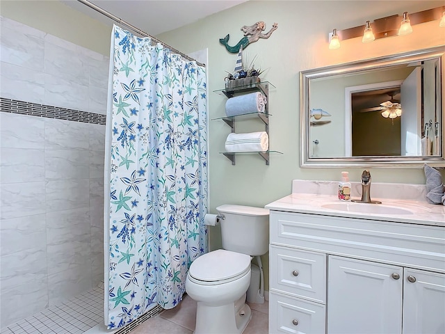 bathroom with ceiling fan, vanity, tile patterned floors, toilet, and walk in shower