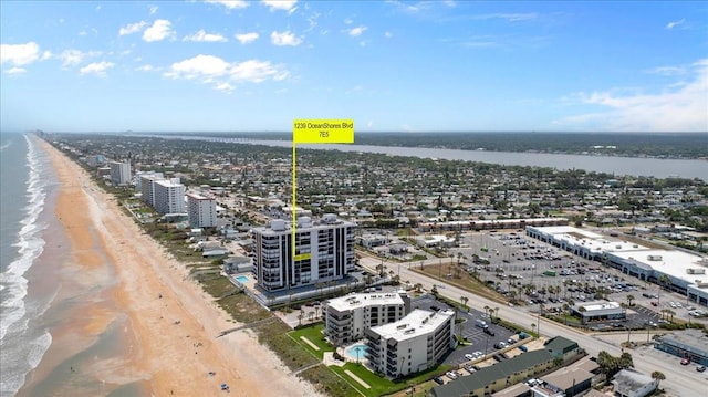 bird's eye view featuring a water view and a view of the beach