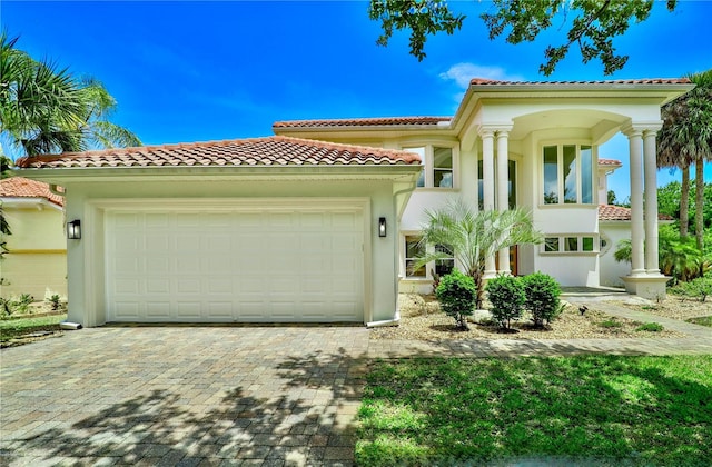 mediterranean / spanish-style home with a garage