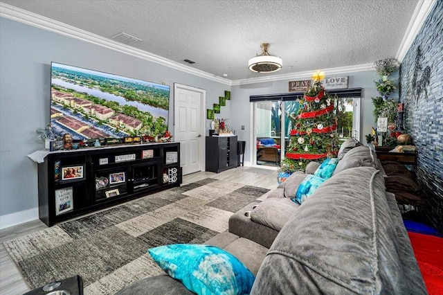 living room with a textured ceiling, hardwood / wood-style flooring, and ornamental molding