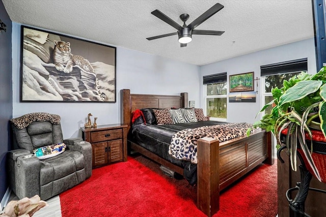 bedroom with ceiling fan and a textured ceiling