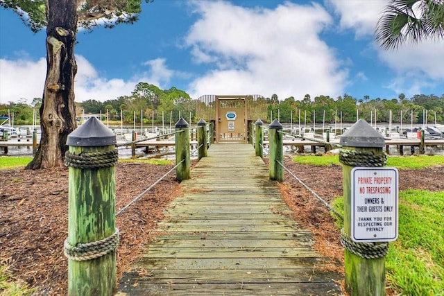 surrounding community featuring a boat dock and a water view