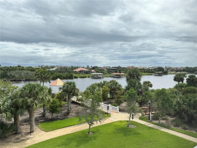 view of property's community featuring a water view and a lawn