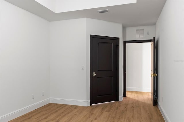 empty room with light hardwood / wood-style flooring