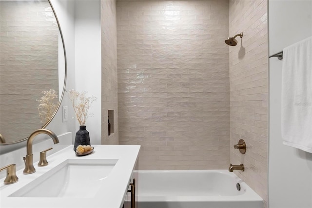 bathroom featuring tiled shower / bath combo and vanity