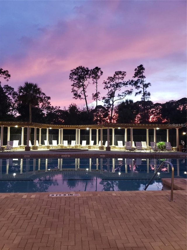 view of pool at dusk