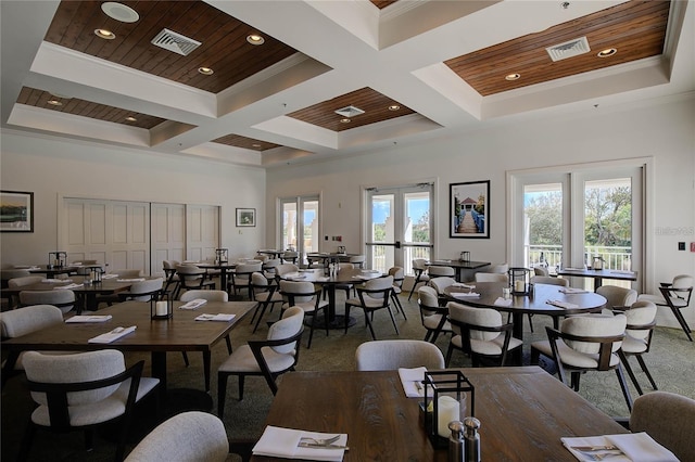 dining room with coffered ceiling, carpet floors, beamed ceiling, and french doors