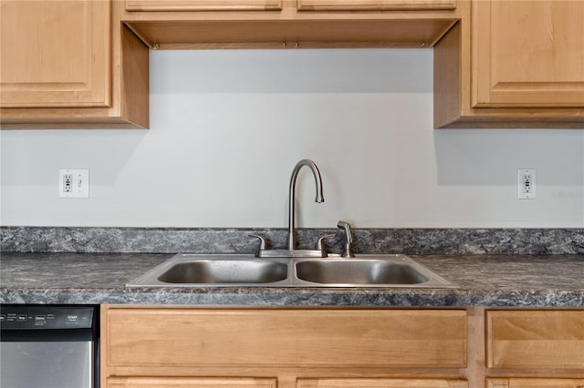 kitchen featuring light brown cabinetry, dishwashing machine, and sink