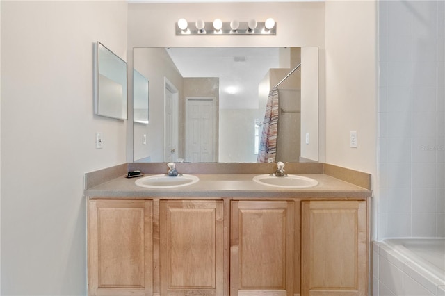 bathroom with tiled shower / bath and dual bowl vanity