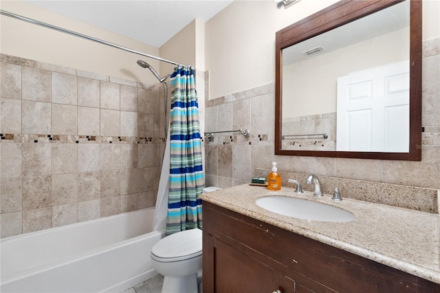 full bathroom with vanity, shower / tub combo, and tile walls