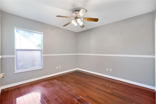 empty room with ceiling fan and dark hardwood / wood-style floors