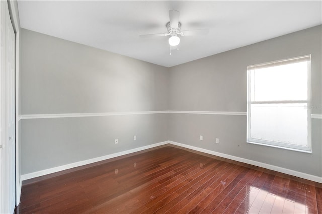 spare room featuring wood-type flooring and ceiling fan