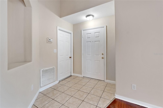 entryway featuring light tile floors