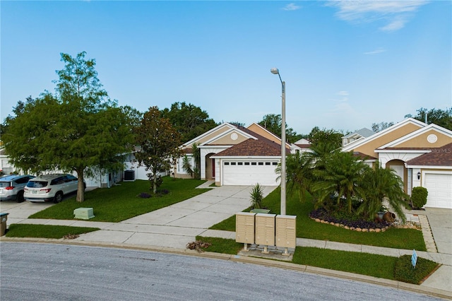 view of front of house featuring a garage and a front lawn