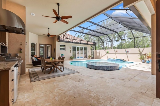 view of pool with area for grilling, a patio, glass enclosure, and an in ground hot tub